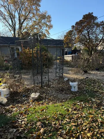 a backyard of a house with table and chairs