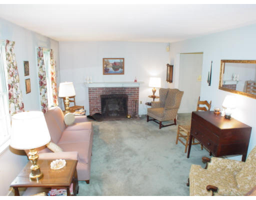 109 Pleasant Valley Road Amesbury, MA 01913 - Photo 2 of 8 a living room with furniture and a fireplace