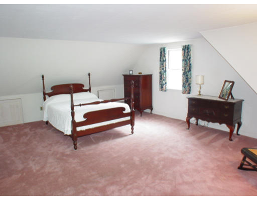 109 Pleasant Valley Road Amesbury, MA 01913 - Photo 5 of 8 a bedroom with a bed and a table in it