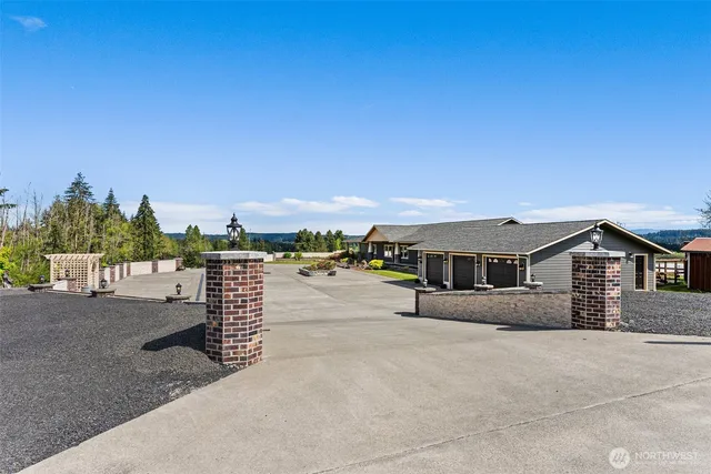 an aerial view of a house with a garden and lake view