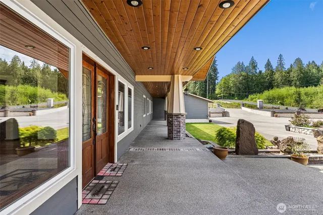 a view of a porch with furniture and a yard