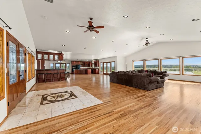 a living room with furniture and a wooden floor