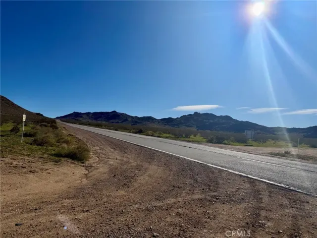 a view of mountain with sunset in background