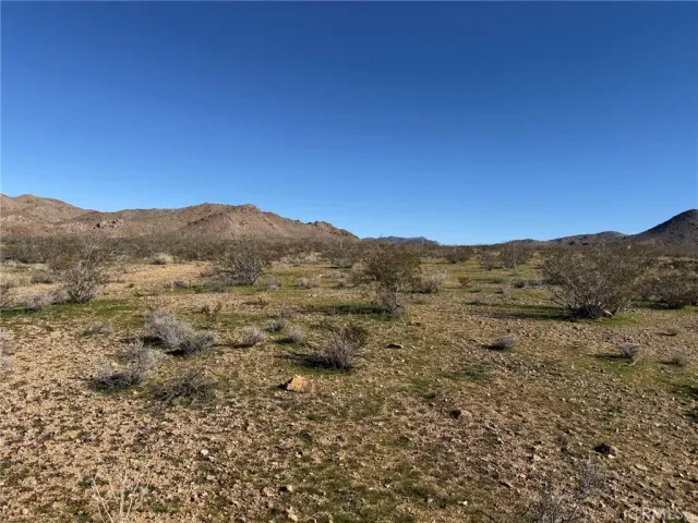 a view of a large mountain with mountains in the background