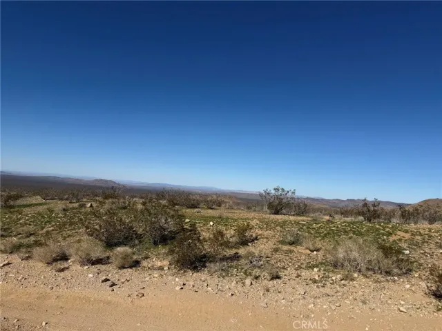 a view of a beach with a mountain in the background