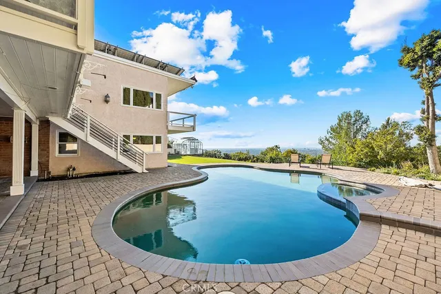 a view of a swimming pool with lounge chair