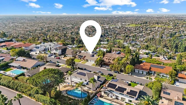 an aerial view of a house with a swimming pool and outdoor space