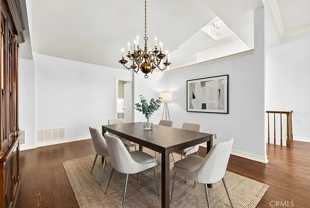 a view of a dining room with furniture wooden floor and a chandelier