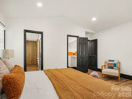 a bedroom with a bed and a lamp