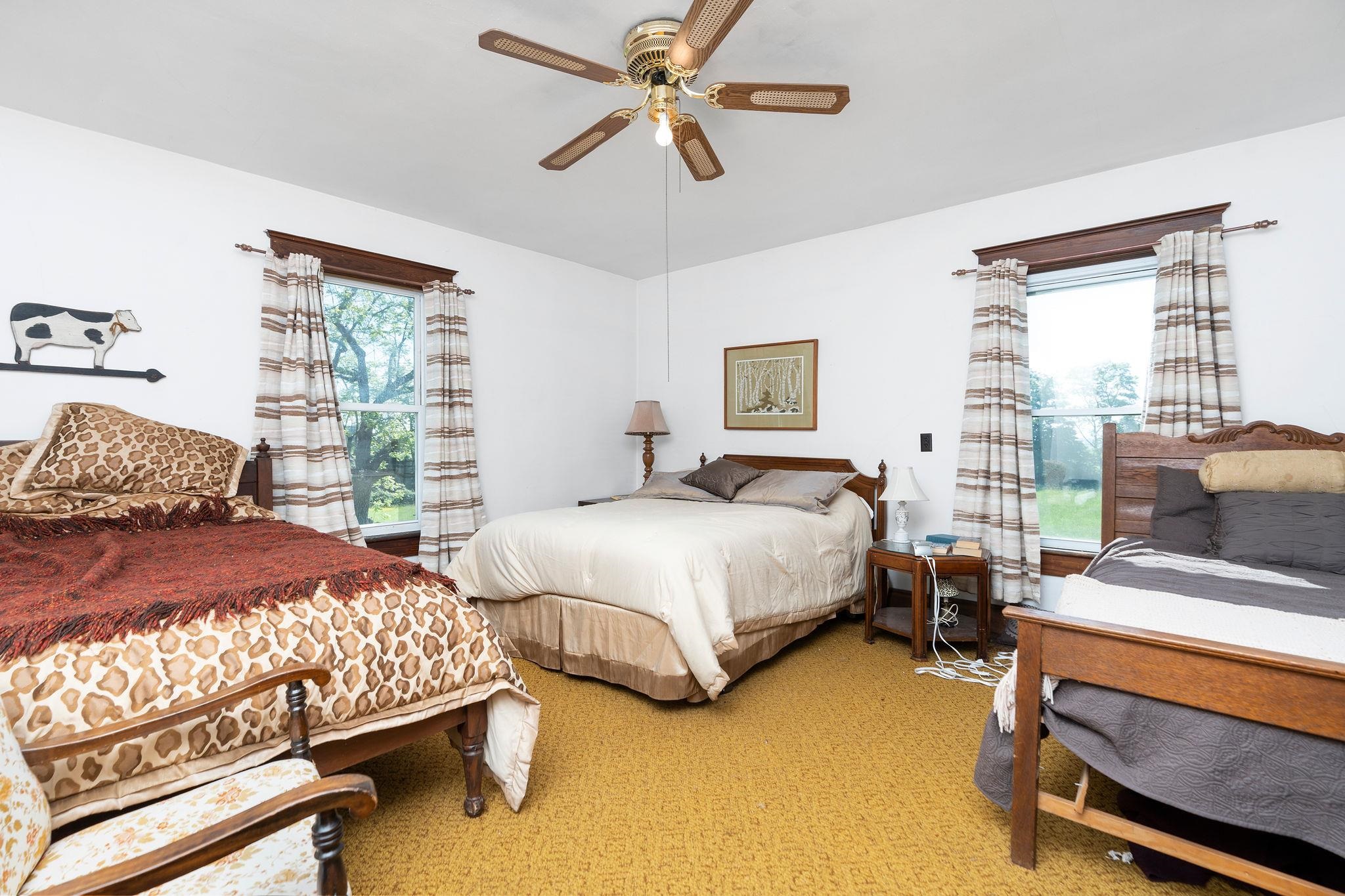 159 Buttermilk Road Mount Sidney, VA 24467 - Photo 25 of 75 a bedroom with two beds and a chandelier