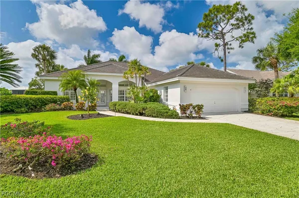 a front view of house with yard and green space