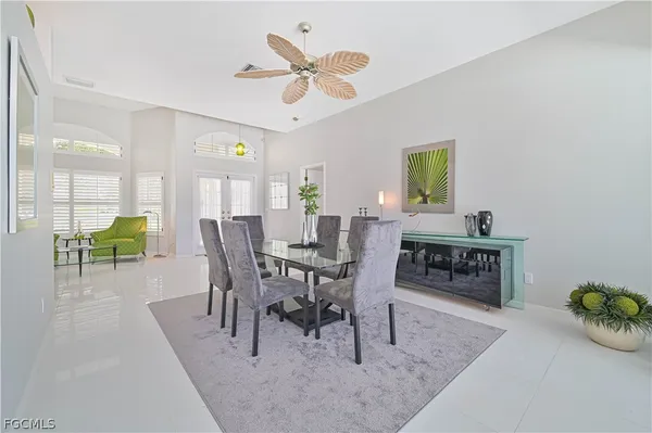 a living room with furniture a fireplace and a chandelier