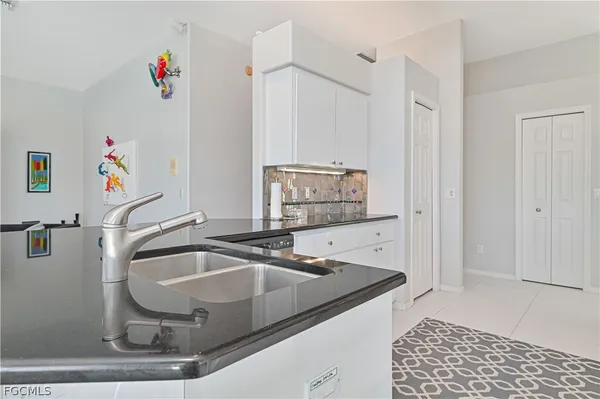 a kitchen with stainless steel appliances granite countertop a sink and cabinets
