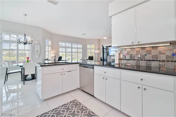 a view of kitchen and dining area with chandelier