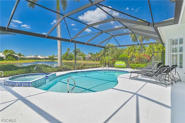 a view of a patio with a table and chairs under an umbrella