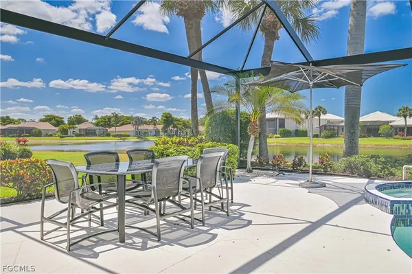 a view of a patio with a table and chairs under an umbrella