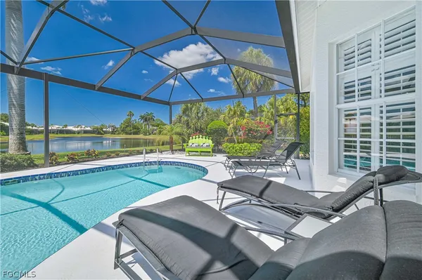 a view of a swimming pool with chairs