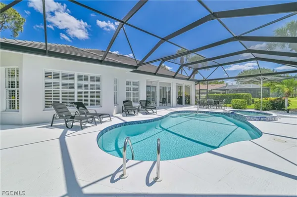 a swimming pool with outdoor seating and yard
