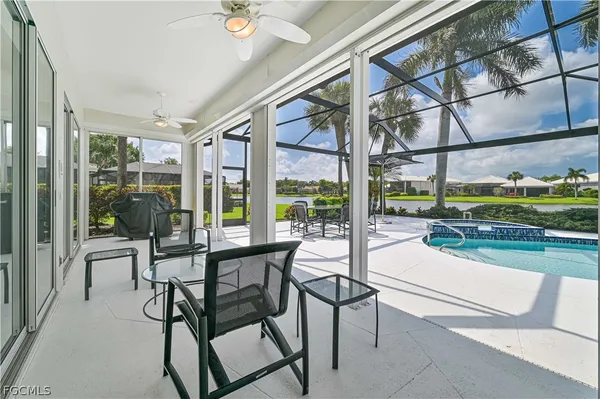 a living room with patio furniture and a floor to ceiling window