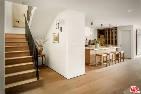 a view of a livingroom with furniture and stairs