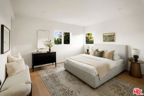 a bedroom with a bed and a couch