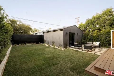 a backyard of a house with table and chairs