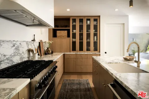 a kitchen with a sink stove and cabinets