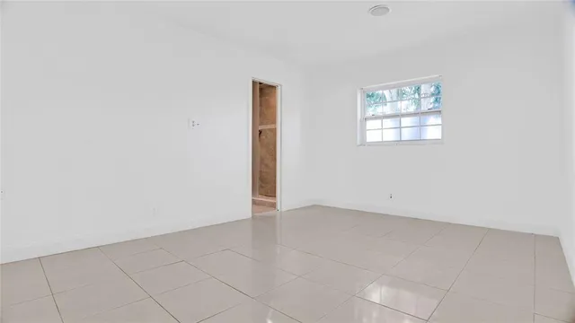 an empty room with a empty space and window