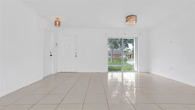 a view of a livingroom with wooden floor and a ceiling fan
