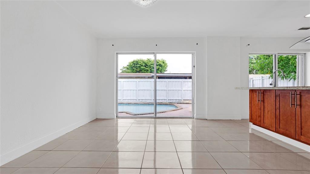 8241 Southwest 3rd Court North Lauderdale, FL 33068 - Photo 20 of 30 a view of a livingroom with wooden floor and a ceiling fan