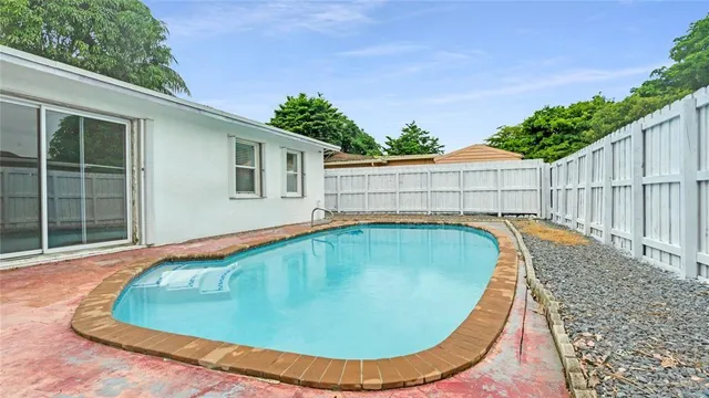 a view of swimming pool with a backyard