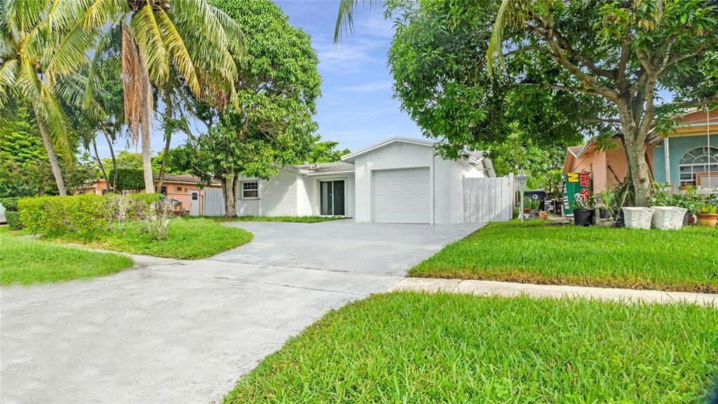 8241 Southwest 3rd Court North Lauderdale, FL 33068 - Photo 28 of 30 a view of a house with a yard and large trees