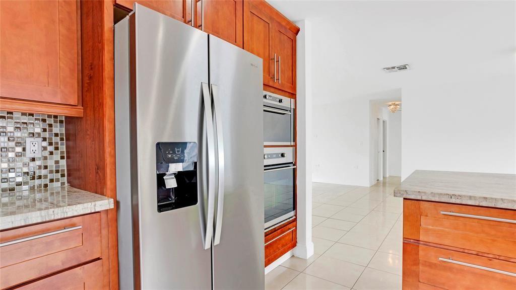 8241 Southwest 3rd Court North Lauderdale, FL 33068 - Photo 8 of 30 a kitchen with stainless steel appliances granite countertop a refrigerator and a stove