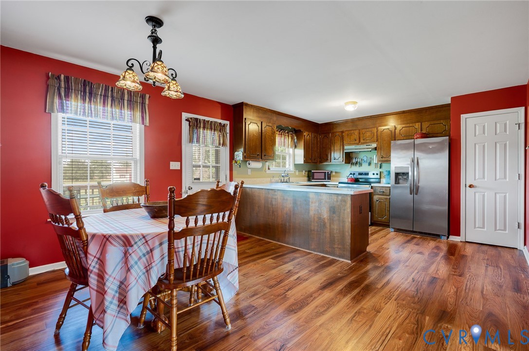 5280 West Quaker Road Disputanta, VA 23875 - Photo 23 of 33 a view of a dining room with furniture window and wooden floor