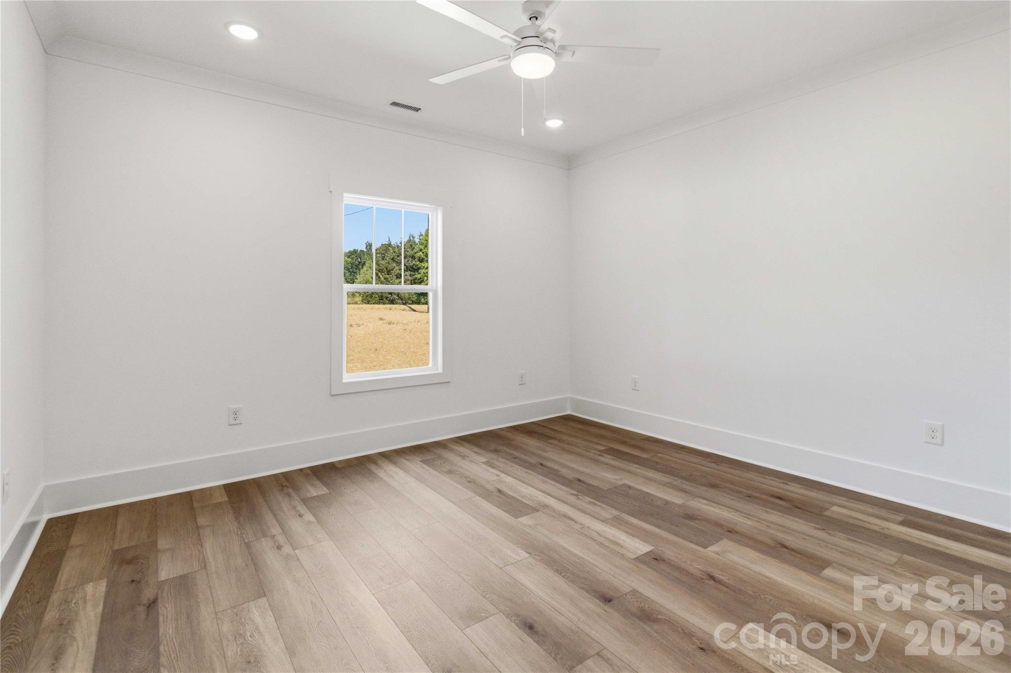352 Adams Road Clover, SC 29710 - Photo 13 of 38 an empty room with wooden floor and windows