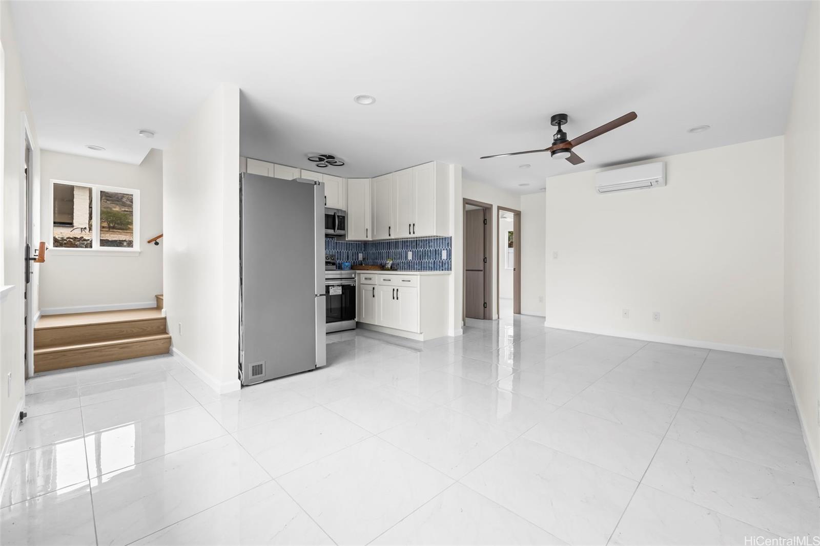 a view of a kitchen with a sink and a refrigerator