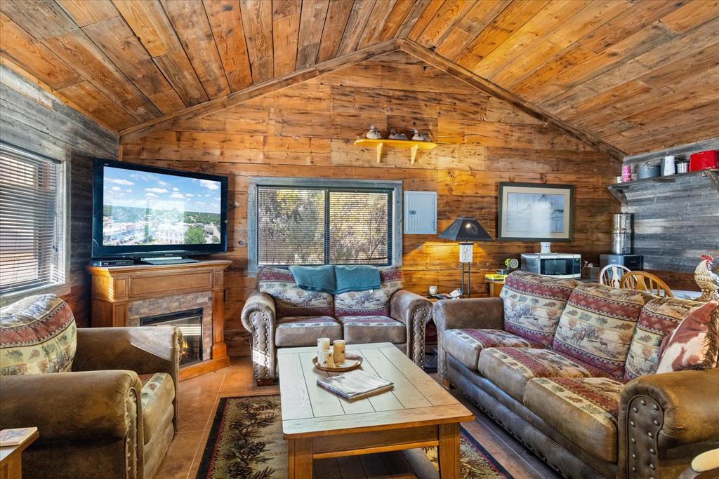 2500 Leech Road Poolville, TX 76487 - Photo 12 of 40 a living room with furniture a flat screen tv and floor to ceiling window