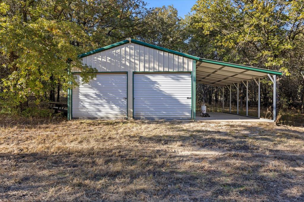 2500 Leech Road Poolville, TX 76487 - Photo 6 of 40 a front view of a house with a yard and garage