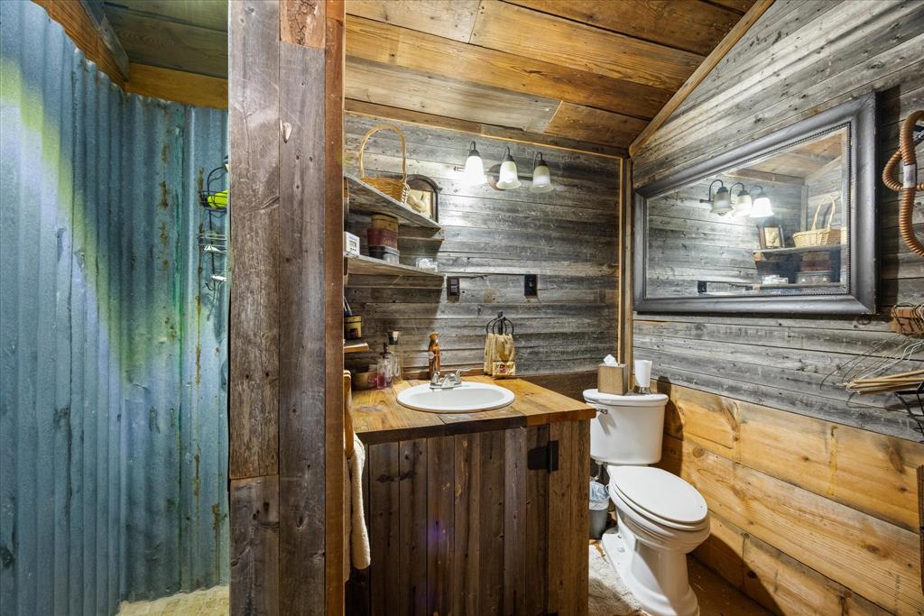 2500 Leech Road Poolville, TX 76487 - Photo 10 of 40 a bathroom with a sink and a toilet