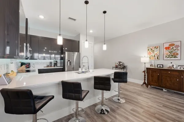 a large kitchen with a table and chairs