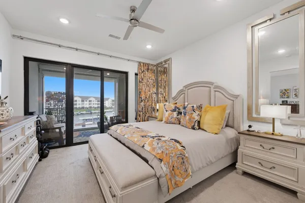 a bedroom with a large bed and a large window