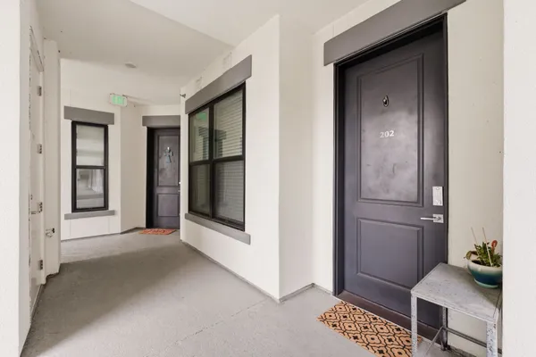 a view of a hallway with a livingroom with furniture