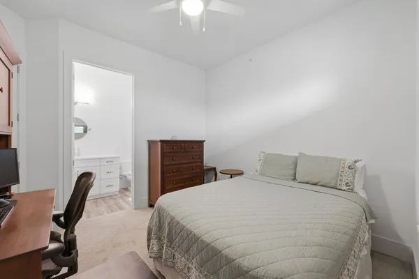 a bedroom with a bed and a desk