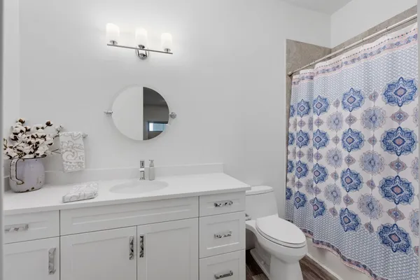 a bathroom with a sink toilet and shower