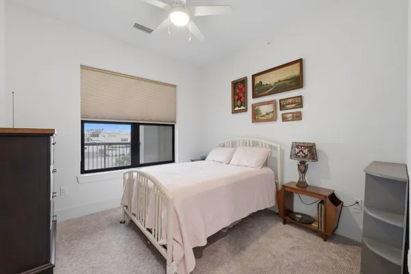a bedroom with a bed and a painting on the wall