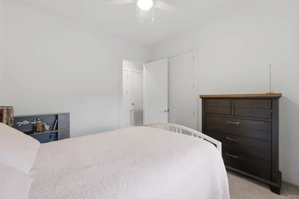 a bedroom with a bed and a dresser