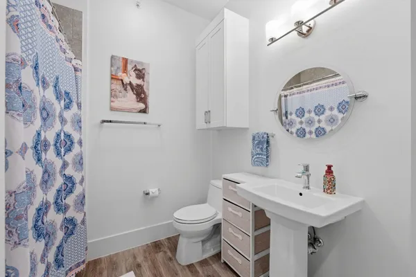 a bathroom with a sink toilet and a mirror