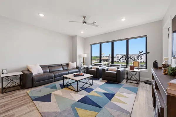 a living room with lots of furniture and a rug
