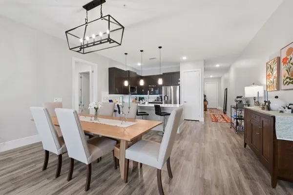 a view of a dining room with furniture wooden floor and chandelier
