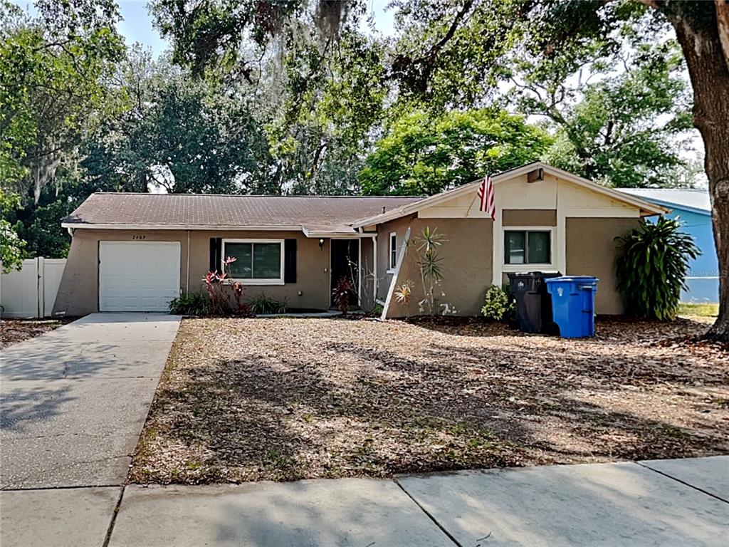 2407 Devonwoode Place Seffner, FL 33584 - Photo 1 of 1 a front view of a house with a yard and potted plants